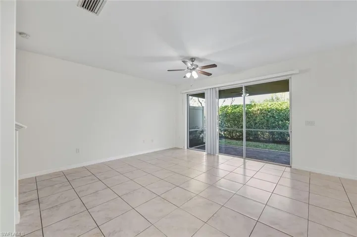 Unfurnished room with a ceiling fan and light tile patterned floors