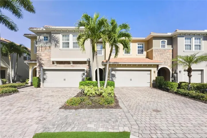 Mediterranean / spanish-style home featuring stone siding, stucco siding, decorative driveway, and an attached garage