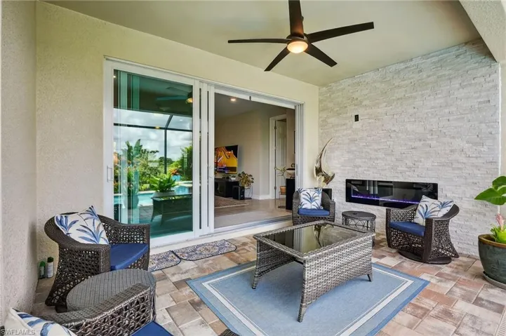 View of patio with outdoor lounge area and ceiling fan