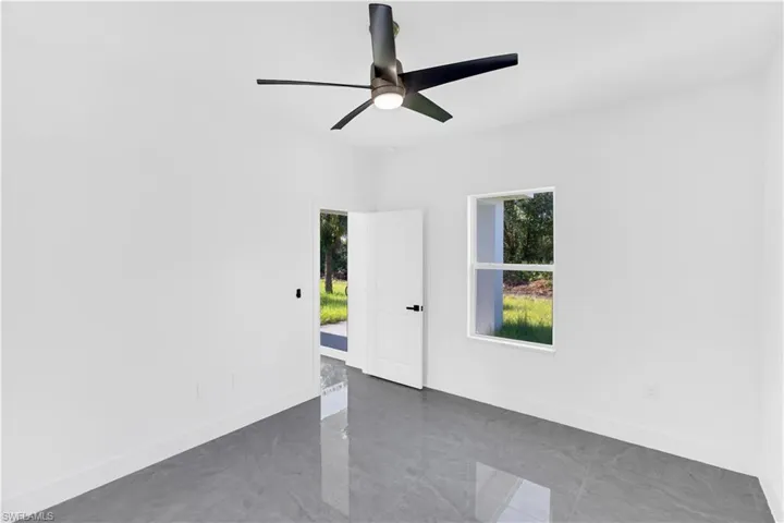Modern interior space featuring gray polished tile flooring and white walls