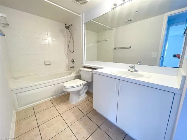 Full bathroom featuring  shower combination, vanity, and light tile patterned floors