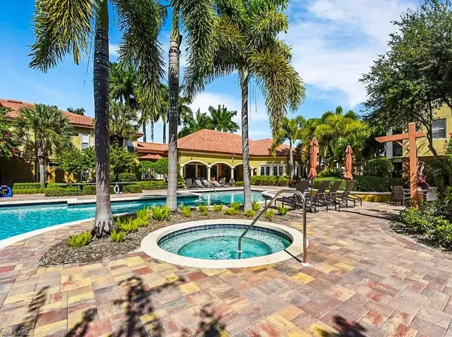 Community pool featuring a patio and a hot tub