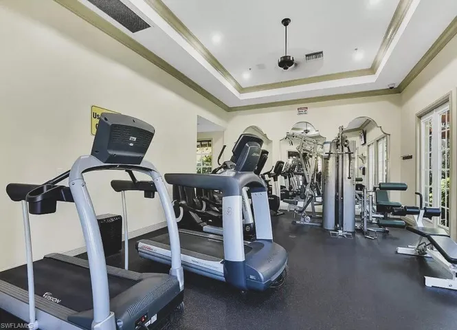 Gym featuring ornamental molding and recessed lighting
