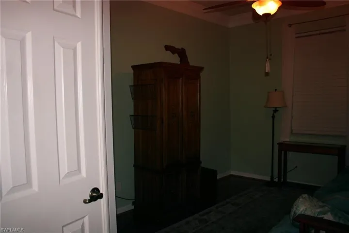 Bedroom with ornamental molding and ceiling fan