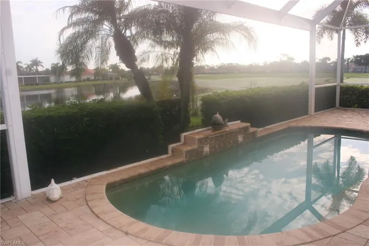 Swimming pool featuring a sunroom and a lanai