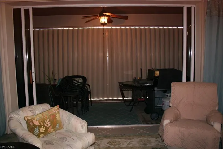 Living area featuring a ceiling fan and tile patterned flooring