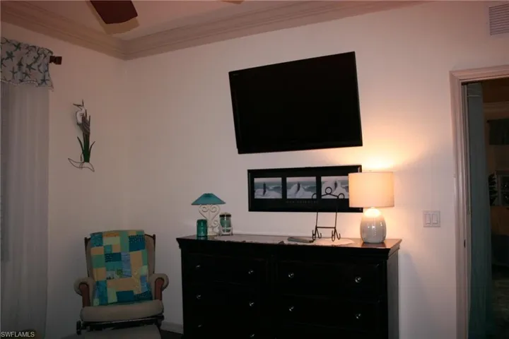 Bedroom with ornamental molding and ceiling fan