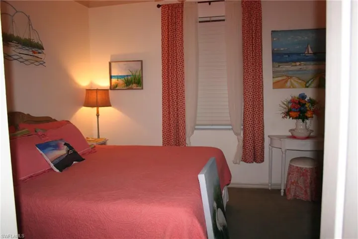 Carpeted bedroom featuring baseboards