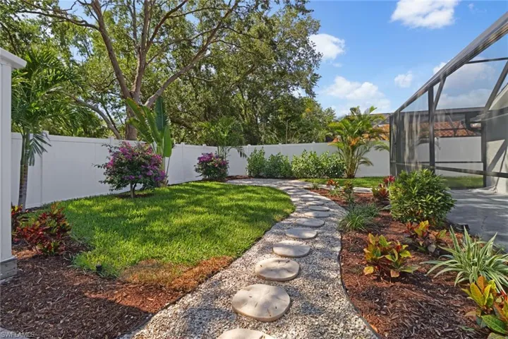 Fenced in yard with a patio and a lanai