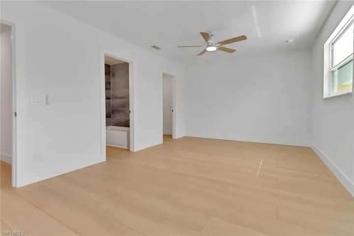 Unfurnished room featuring ceiling fan and light hardwood / wood-style flooring