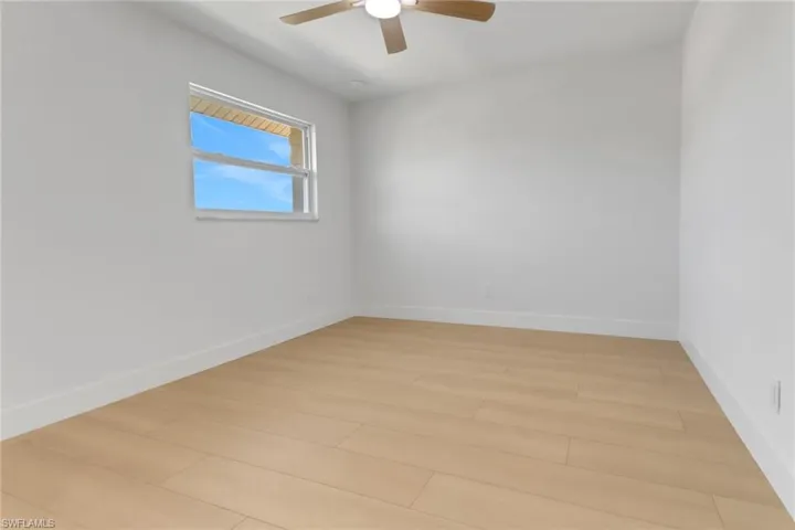 Spare room with ceiling fan and light hardwood / wood-style flooring