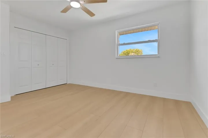 Unfurnished bedroom featuring ceiling fan, a closet, and light hardwood / wood-style floors