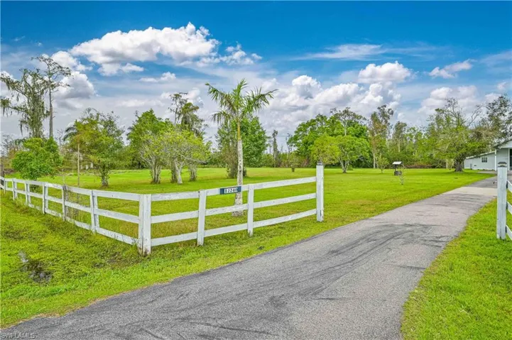 View of gate featuring a rural view and a lawn