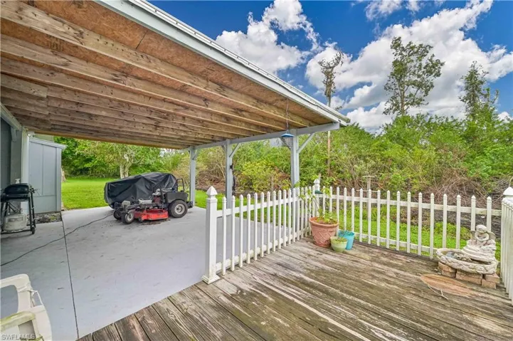 Wooden deck featuring a grill