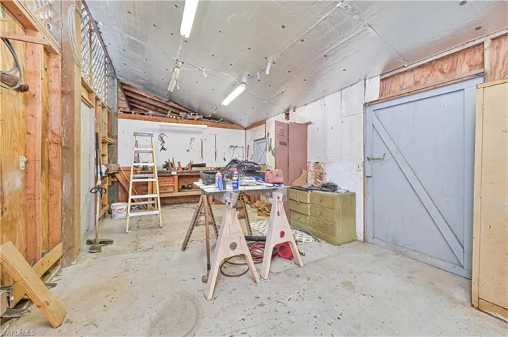 Miscellaneous room featuring a workshop area and lofted ceiling