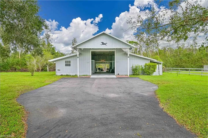 View of front of home with a front yard and a carport