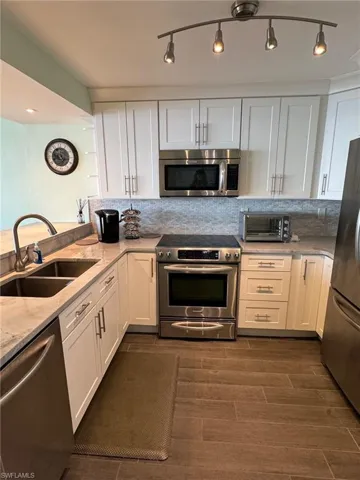 Beautiful kitchen with backsplash and quartzite countertops... and view!