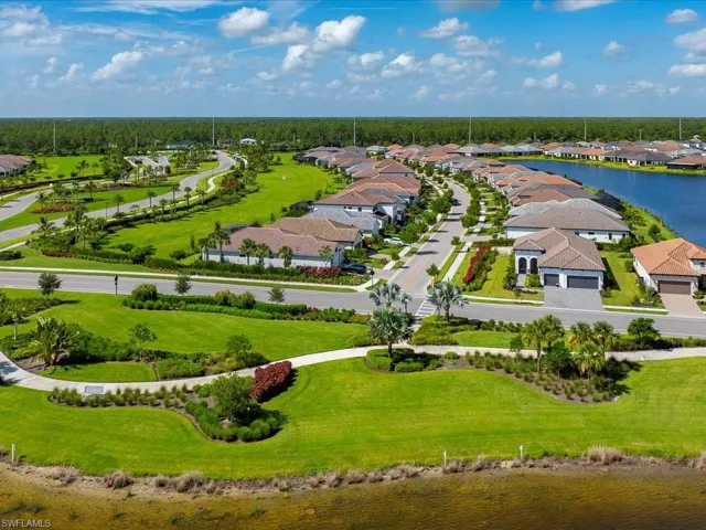 Aerial view of residential area featuring a large body of water