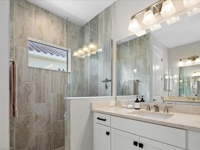 Full bath featuring walk in shower and vanity
