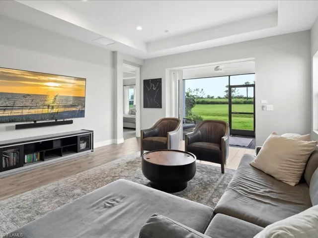 Living area with wood finished floors, recessed lighting, and a coffer ceiling