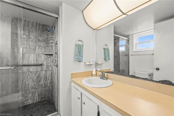 The shower was redone with large tile and glass door.