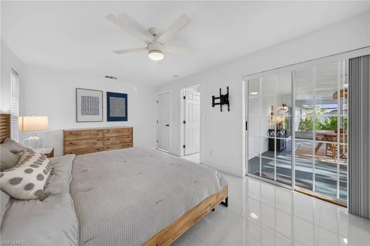 Primary Bedroom overlooks the large oversized lanai with hurricane glass sliding doors.