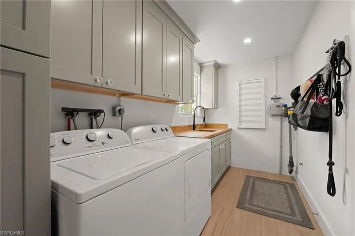 A beautiful new laundry room was just recently added and has an abundance of storage.