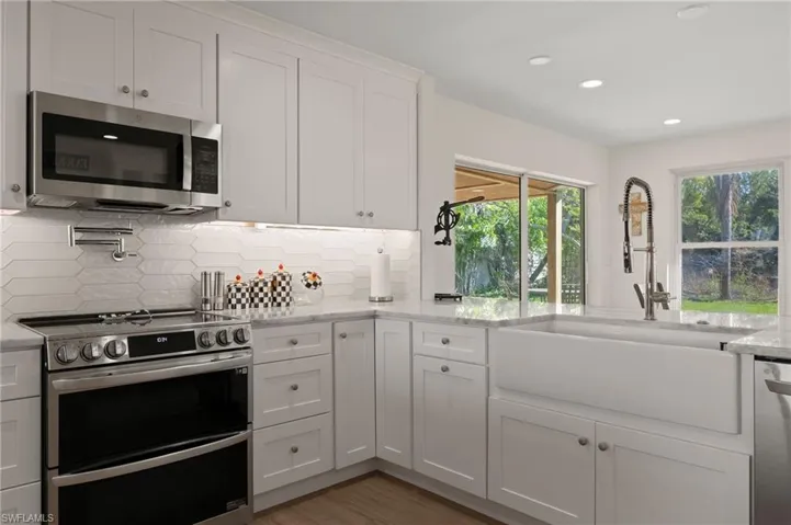 Beautiful tile back splash, a new double oven, farmhouse sink and much more.