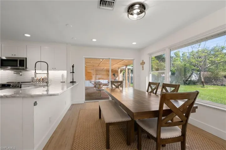 The spacious dining room looks both outside and onto the outdoor deck.