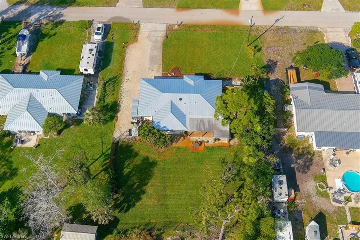 This aerial photo shows the large front and backyards as well as an extra large driveway.