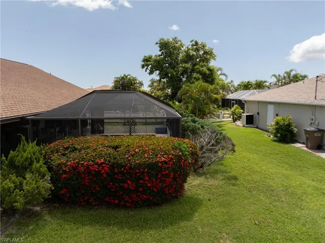 View of grassy yard with a lanai