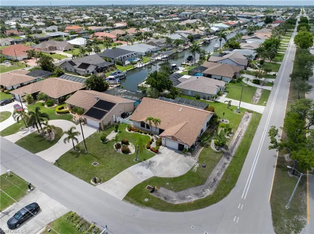 Aerial view of property and surrounding area with a large body of water and nearby suburban area