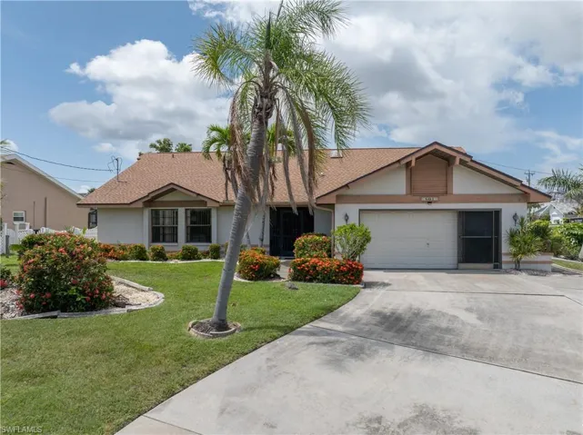 Ranch-style home featuring stucco siding, concrete driveway, a front lawn, and an attached garage