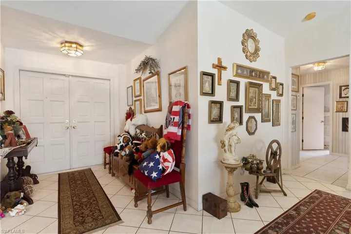 Foyer with light tile patterned flooring