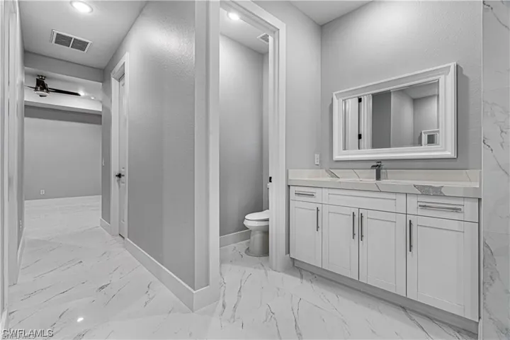 Bathroom featuring vanity and toilet