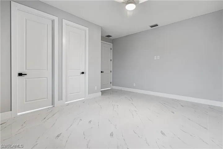 Unfurnished bedroom with ceiling fan