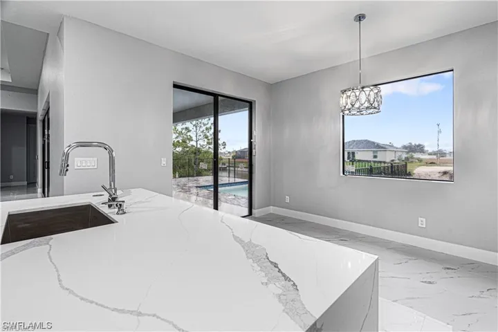 Bedroom featuring multiple windows, access to outside, and sink