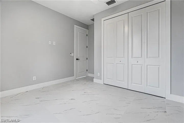 Unfurnished bedroom with a closet