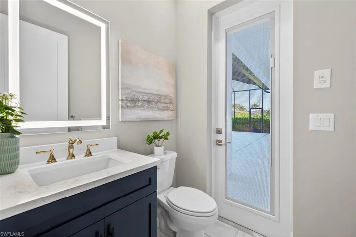 Half bathroom with vanity and toilet