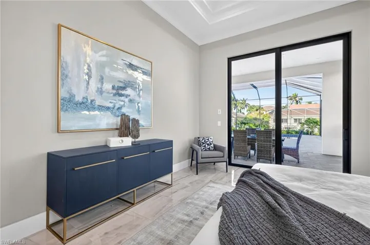 Bedroom with crown molding and access to exterior