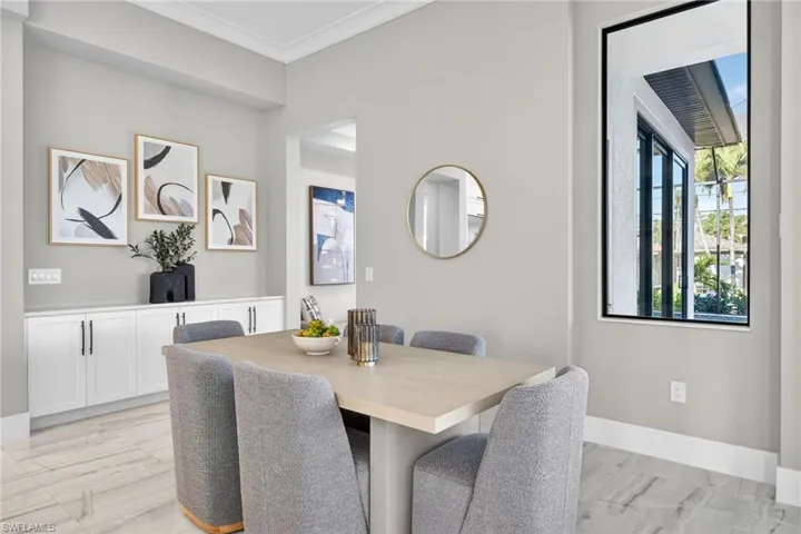 Dining room featuring crown molding and baseboards