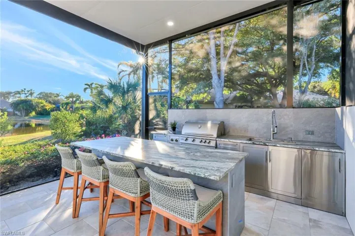 New outdoor Kitchen with built-in grill, large stainless steel sink and leathered granite countertops