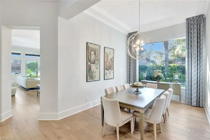 Elegant dining room with designer chandelier and stunning natural light