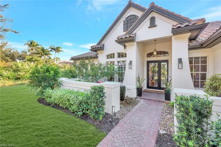 A beautiful brick papered pathway, leads the way to a stunning entryway
