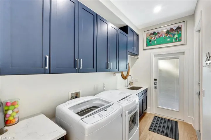 Spacious laundry room with ample storage and two convenient access doors to both the driveway and garage.