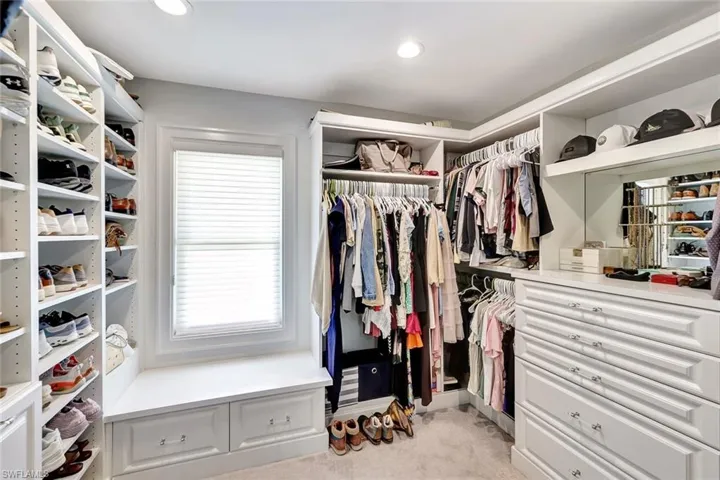 Walk in closet featuring light carpet