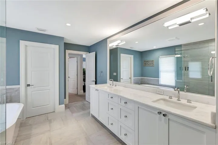 Bathroom featuring vanity, independent shower and bath, and tile patterned flooring
