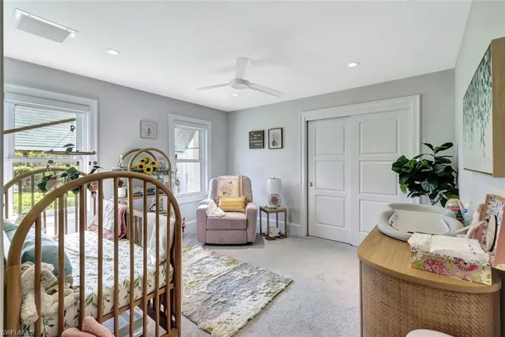 Bedroom with multiple windows, a closet, carpet flooring, and ceiling fan