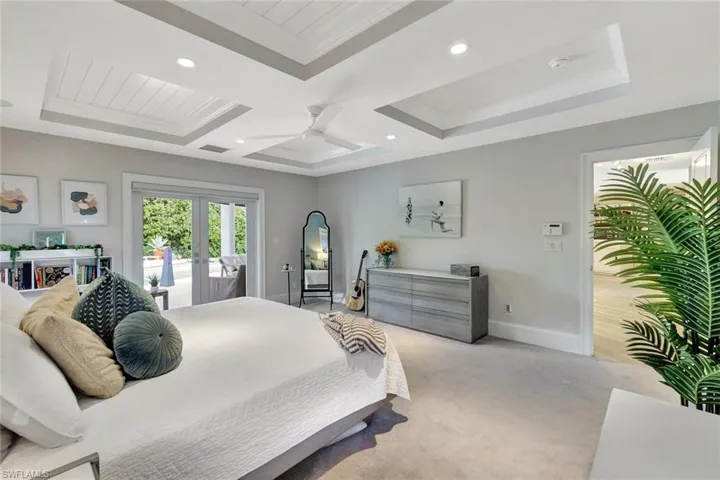 Bedroom with french doors, access to outside, light carpet, ornamental molding, and ceiling fan