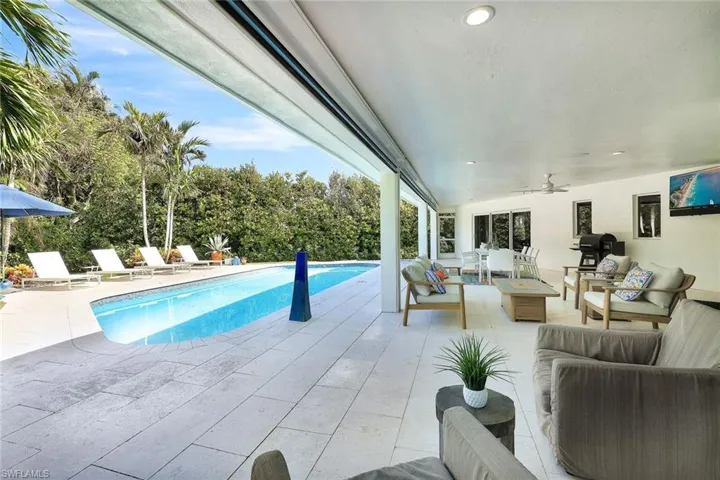View of pool with a patio, ceiling fan, and an outdoor hangout area